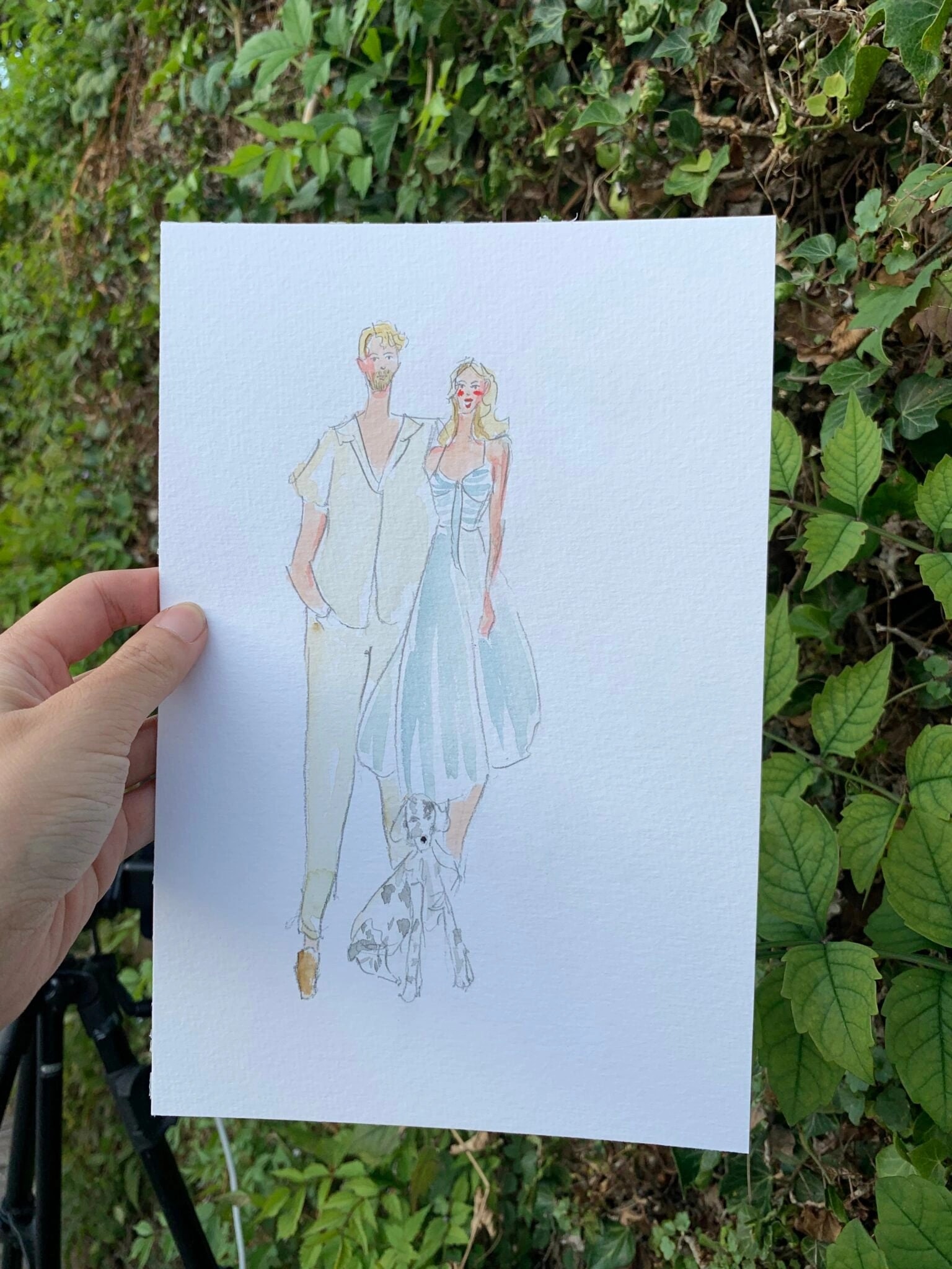 Live gemaltes Aquarell-Porträt eines Paars mit Hund an einer Hochzeit in Talloires.