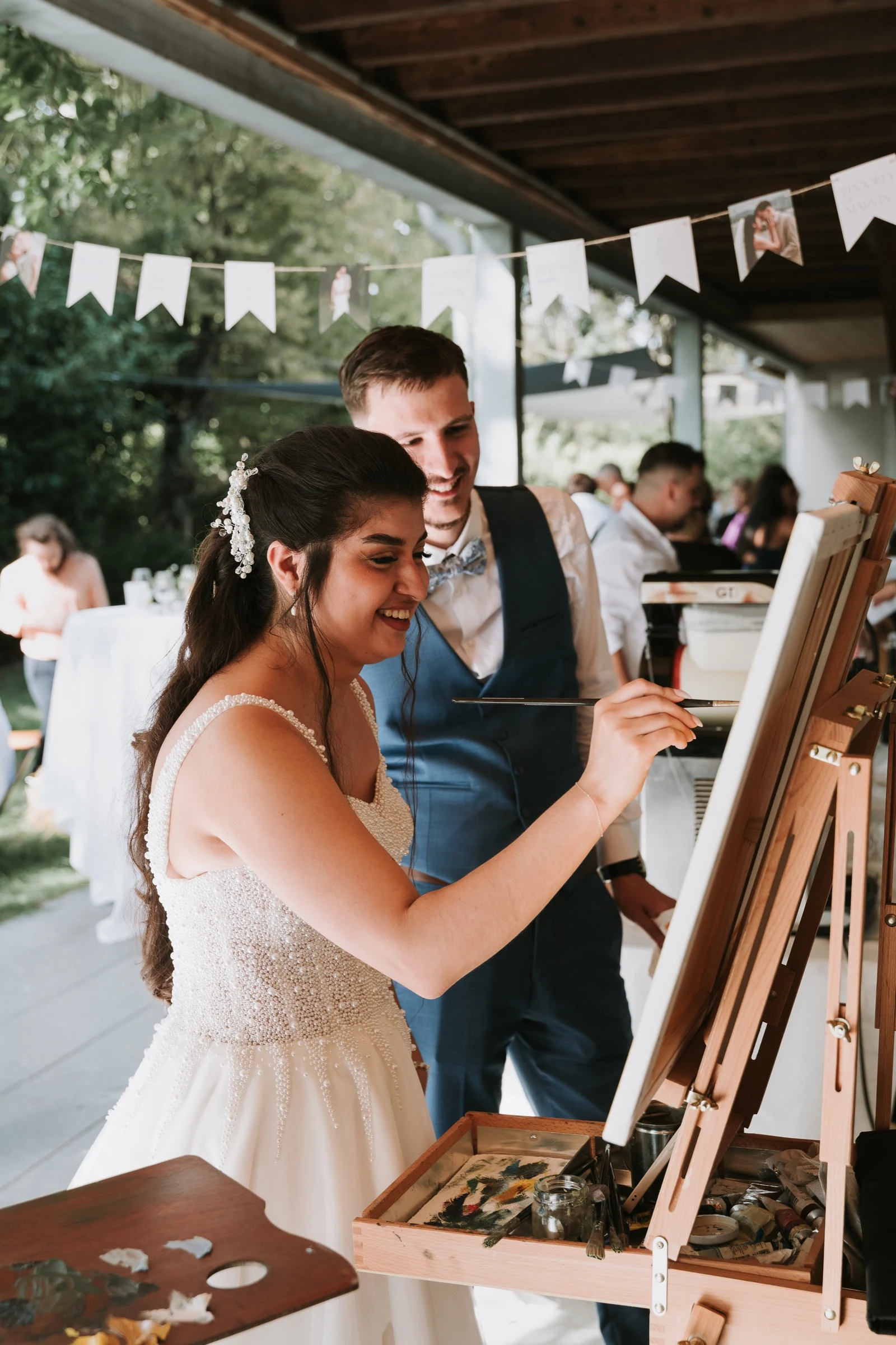 The bride adding her own brushstroke to her wedding painting