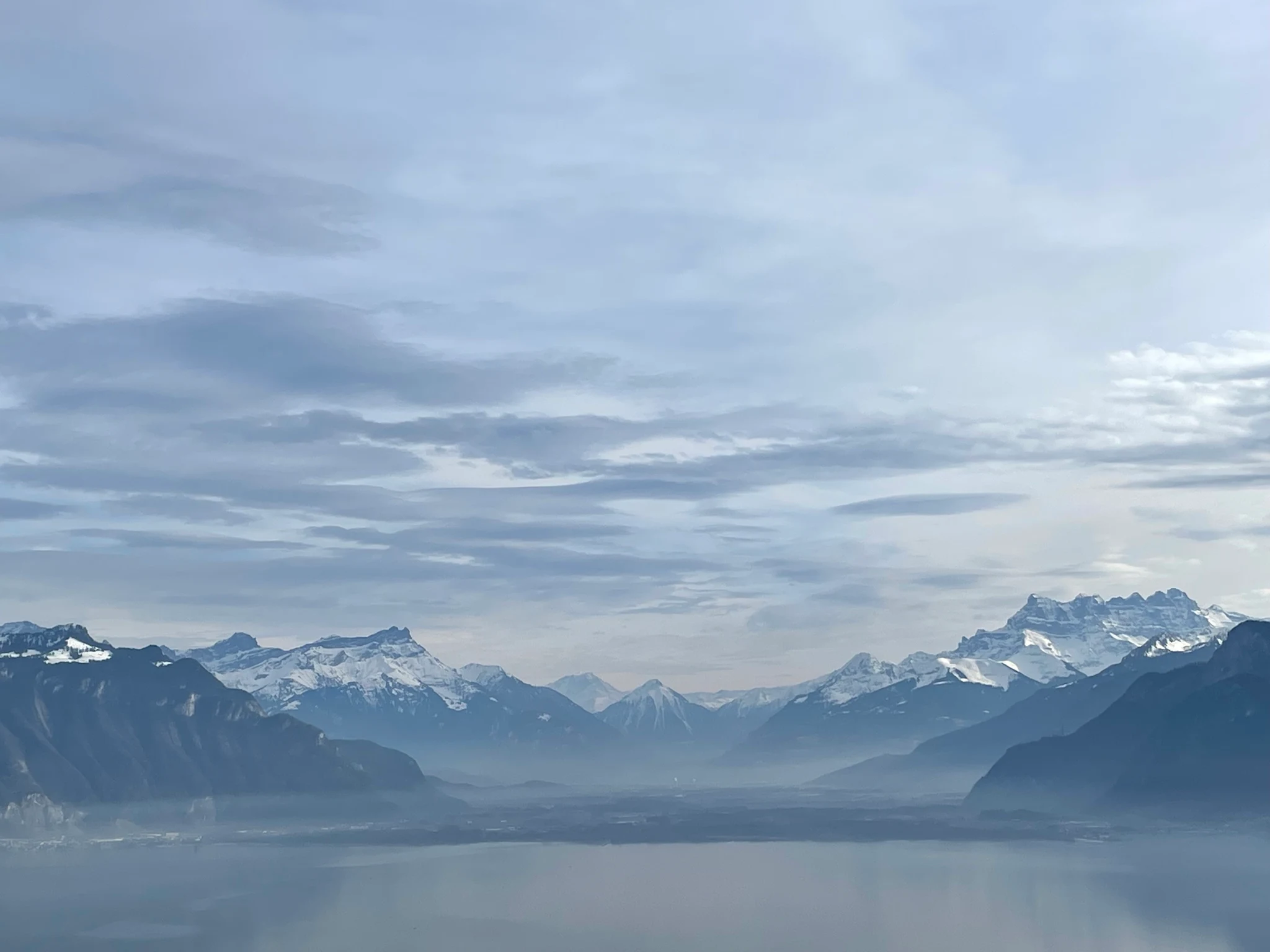 Snow-capped Alps rising above Lake Geneva in winter, seen from Le Mirador
