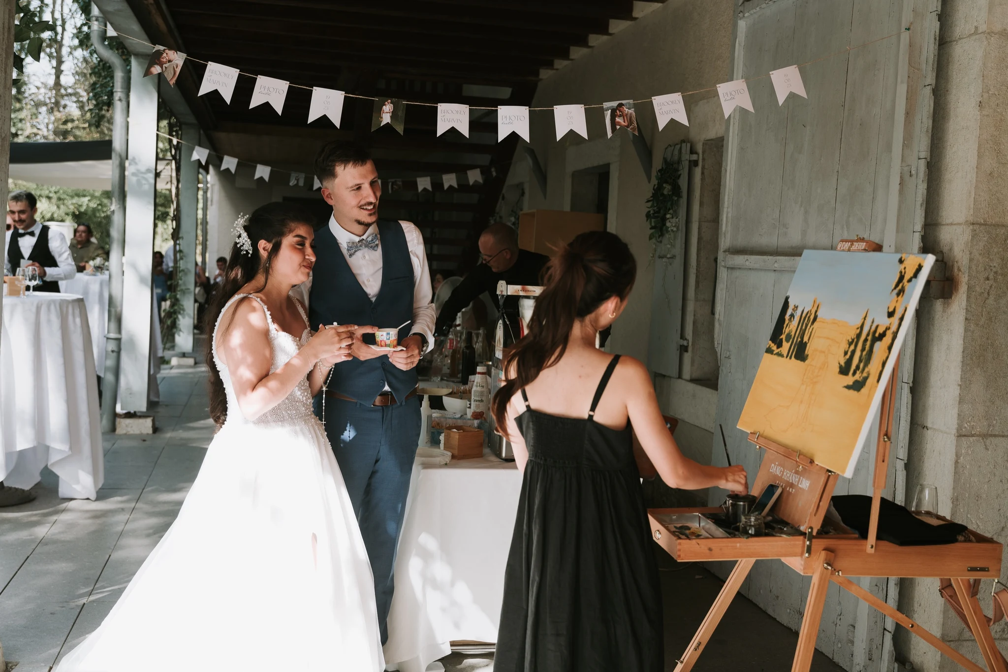 Bride and groom discovering the surprise painting of their first moments as a married couple