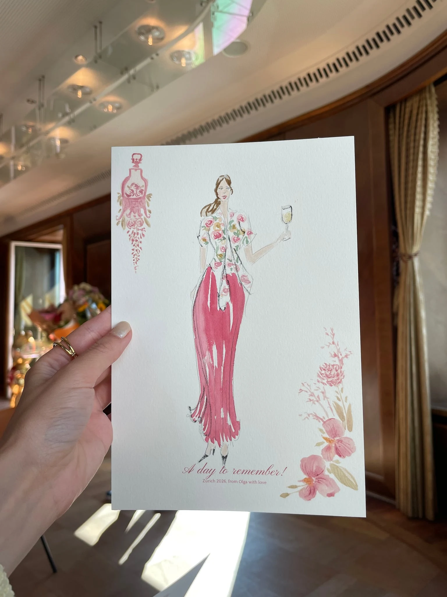 Live watercolor illustration of a guest in a floral blouse and red skirt, champagne in hand at a birthday party at AMERON Zürich Bellerive au Lac.