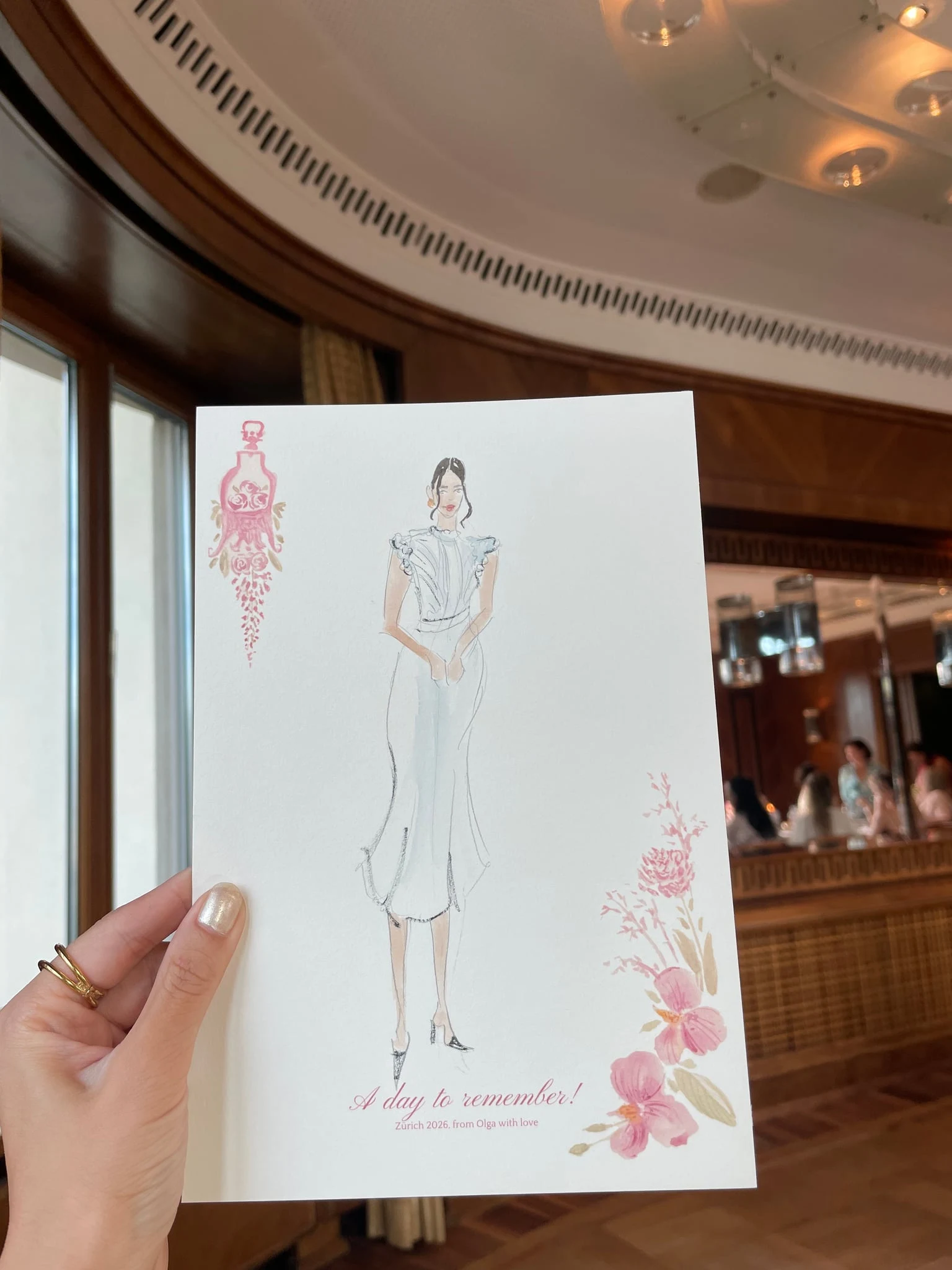 Live watercolor illustration of a guest in a white ruffled dress at a birthday party at AMERON Zürich Bellerive au Lac.
