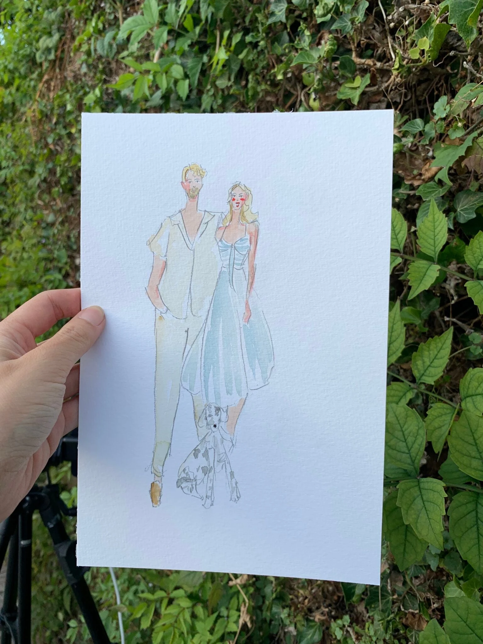 Live watercolor portrait of a couple and their dog at a wedding in Talloires.