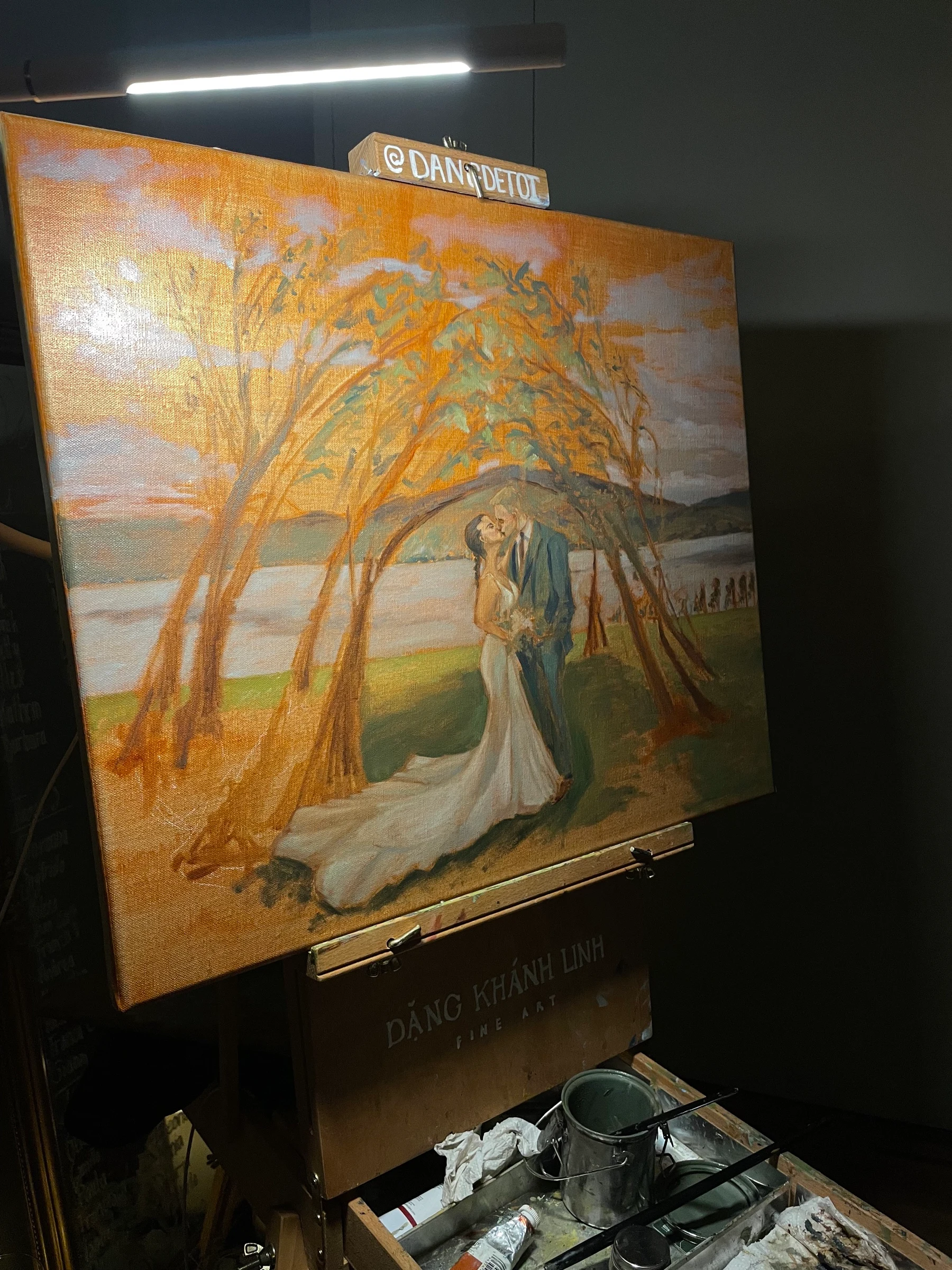 Step 3 of a live wedding painting: the couple’s kiss under the tree dome at the end of the night