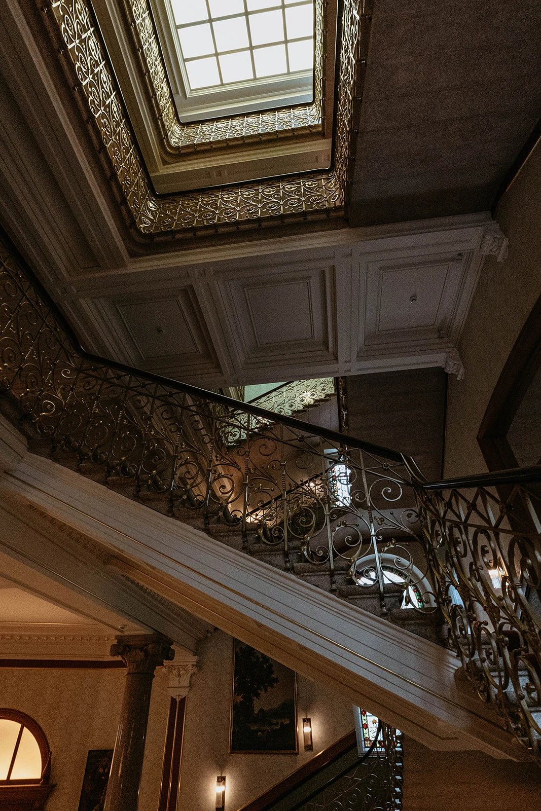 The grand interior staircase of The Dolder Grand hotel in Zurich, captured by Kuenzli Photography.