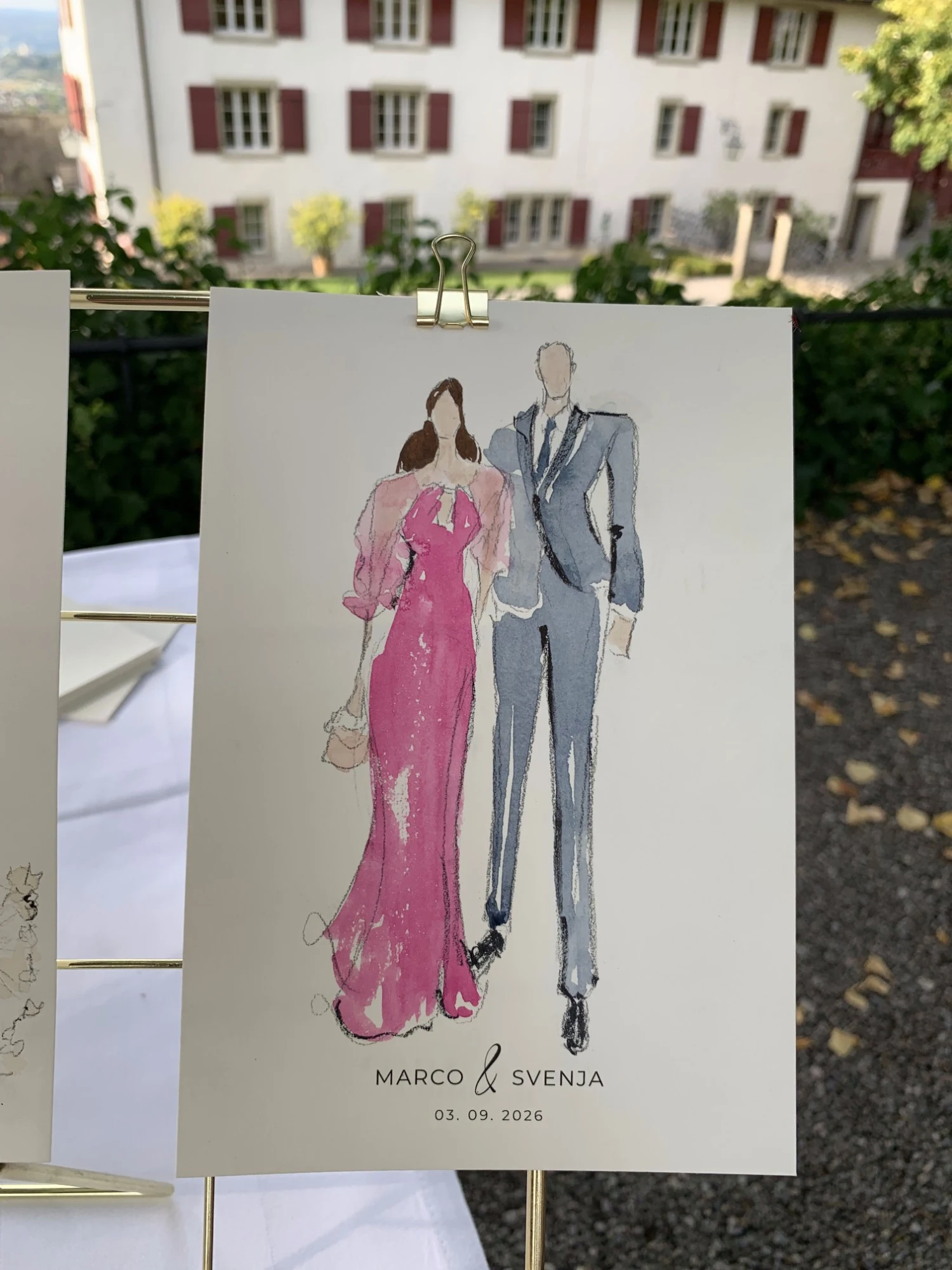 Live watercolor fashion sketch of a guest couple at Schloss Lenzburg: a fuchsia gown and a grey-blue suit.